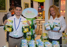 Joshua Estebane and Kim Kinnavy with West Pak Avocado, Inc. show I Love Avocodos in mesh bags.